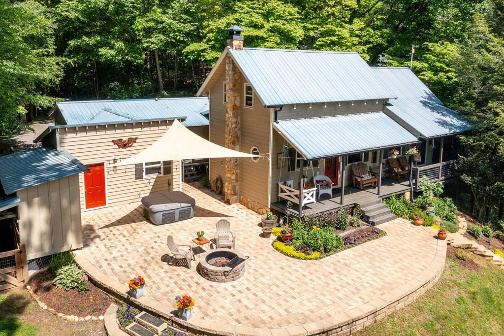 an aerial view of a house with outdoor seating