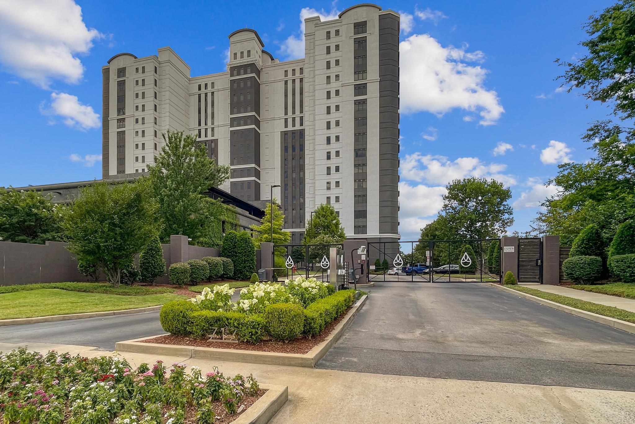 a front view of a residential apartment building with a yard