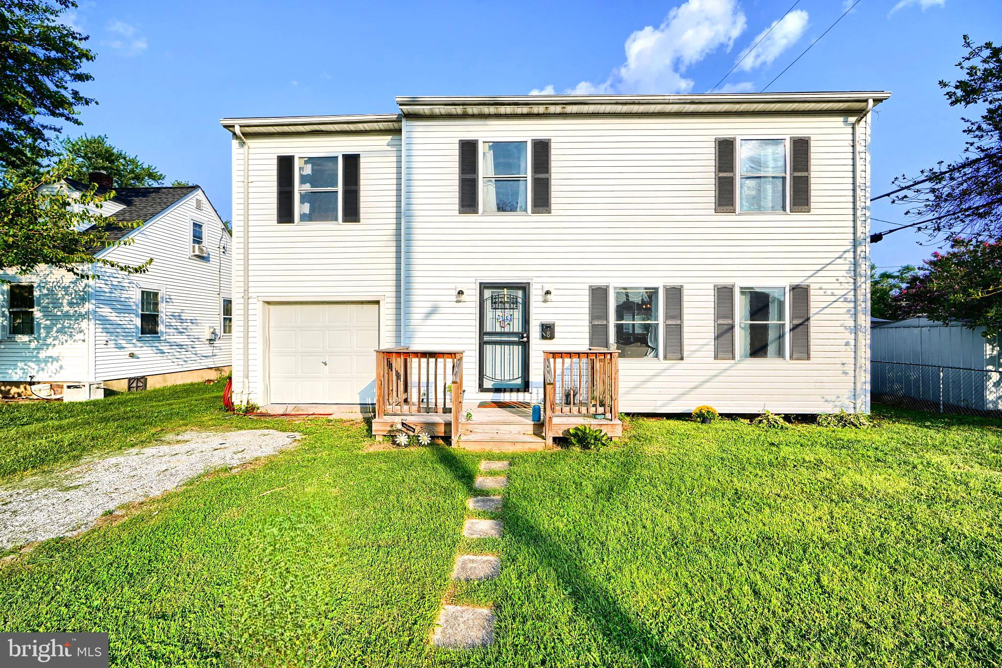 a house view with a sitting space and garden