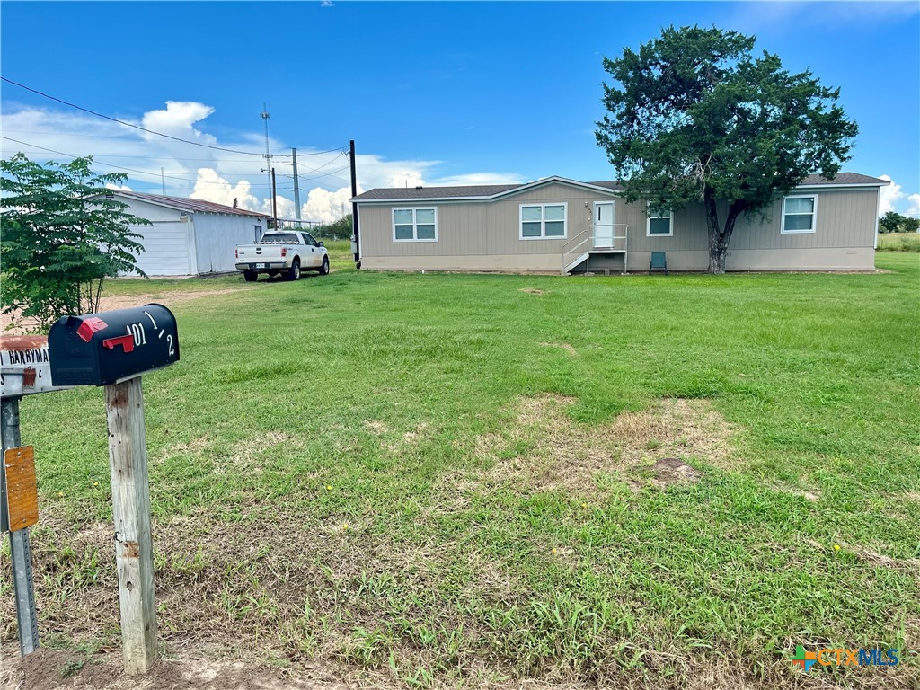 a view of house with yard