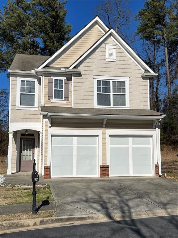 a front view of a house with a yard and garage