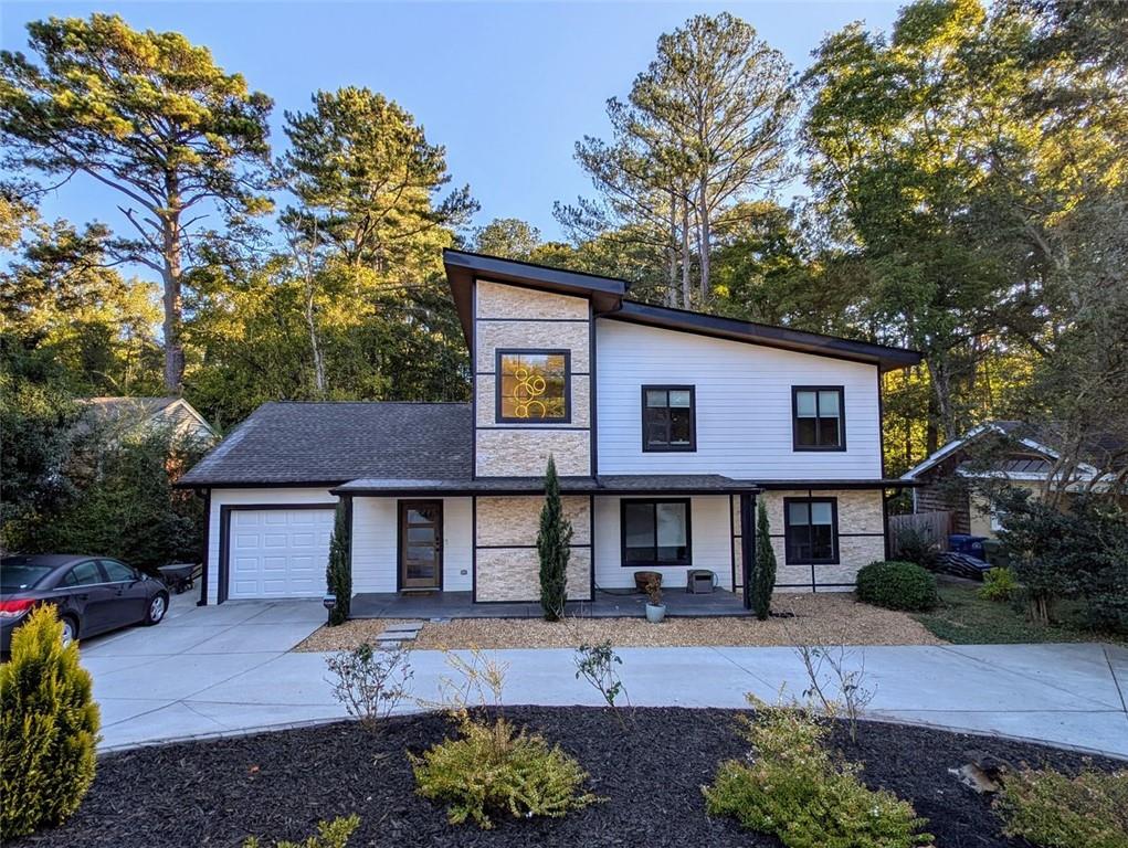 a front view of a house with a garden and patio