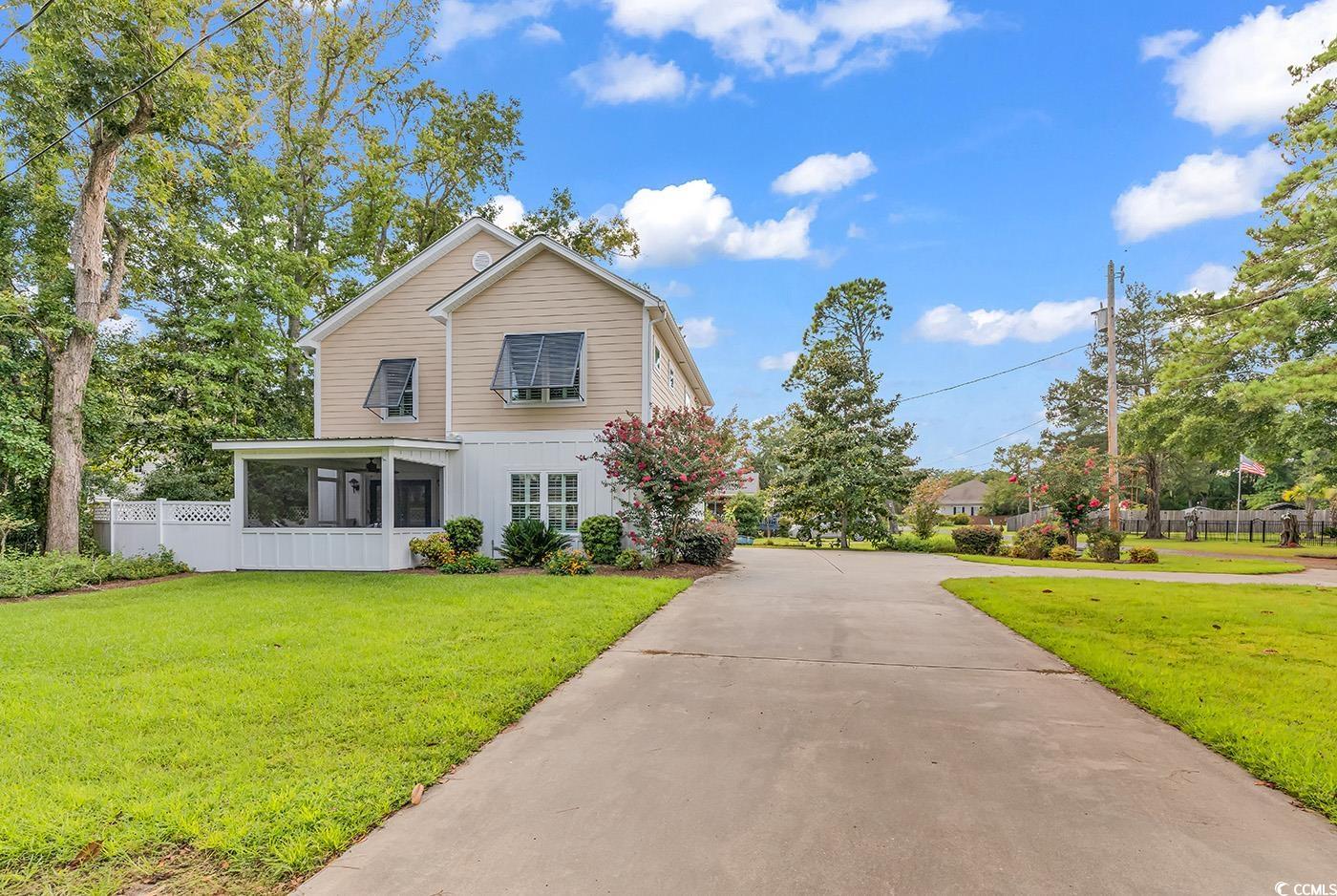 View of front property featuring a sunroom and a f