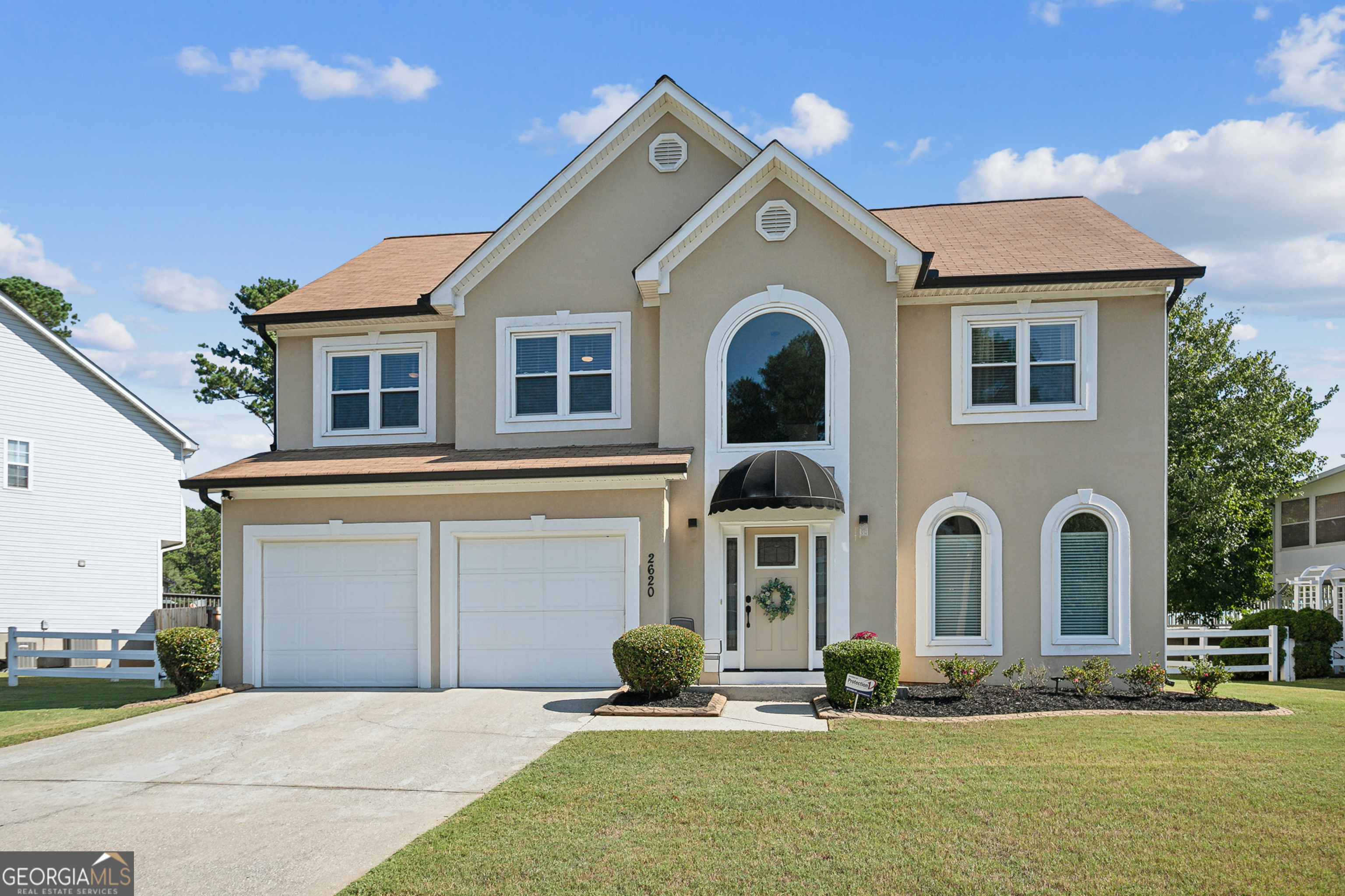 a front view of a house with a yard