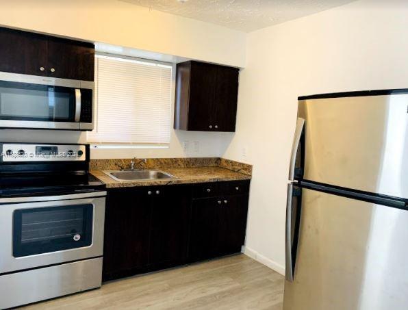 a kitchen with a refrigerator stove and microwave