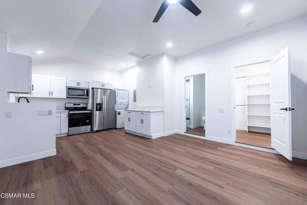 a view of a kitchen with wooden floor