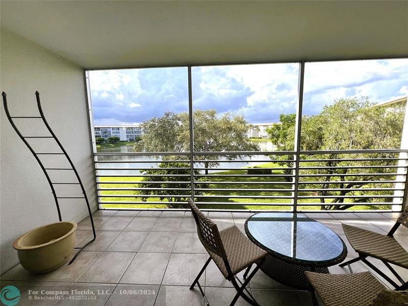 a view of a balcony with table and chairs