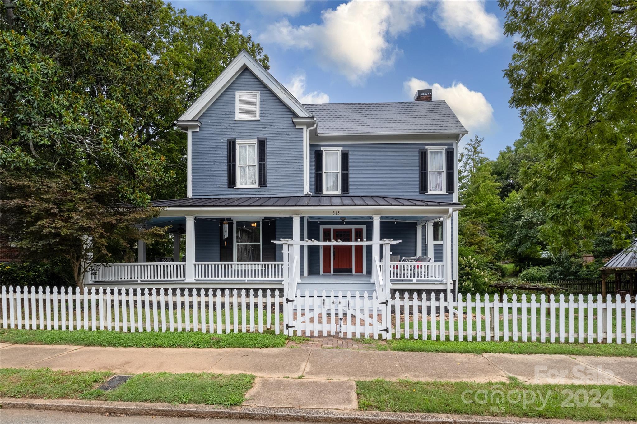 a front view of a house with a garden and deck