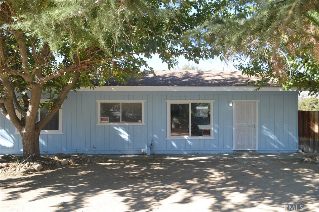 a house that has a tree in front of it