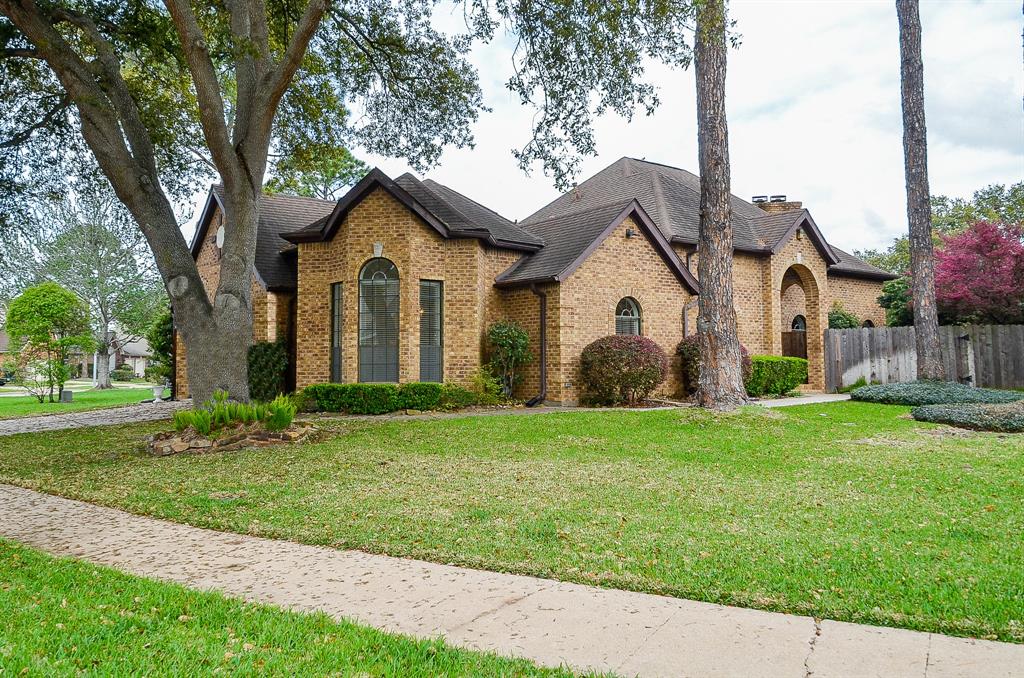 a front view of a house with a garden and yard