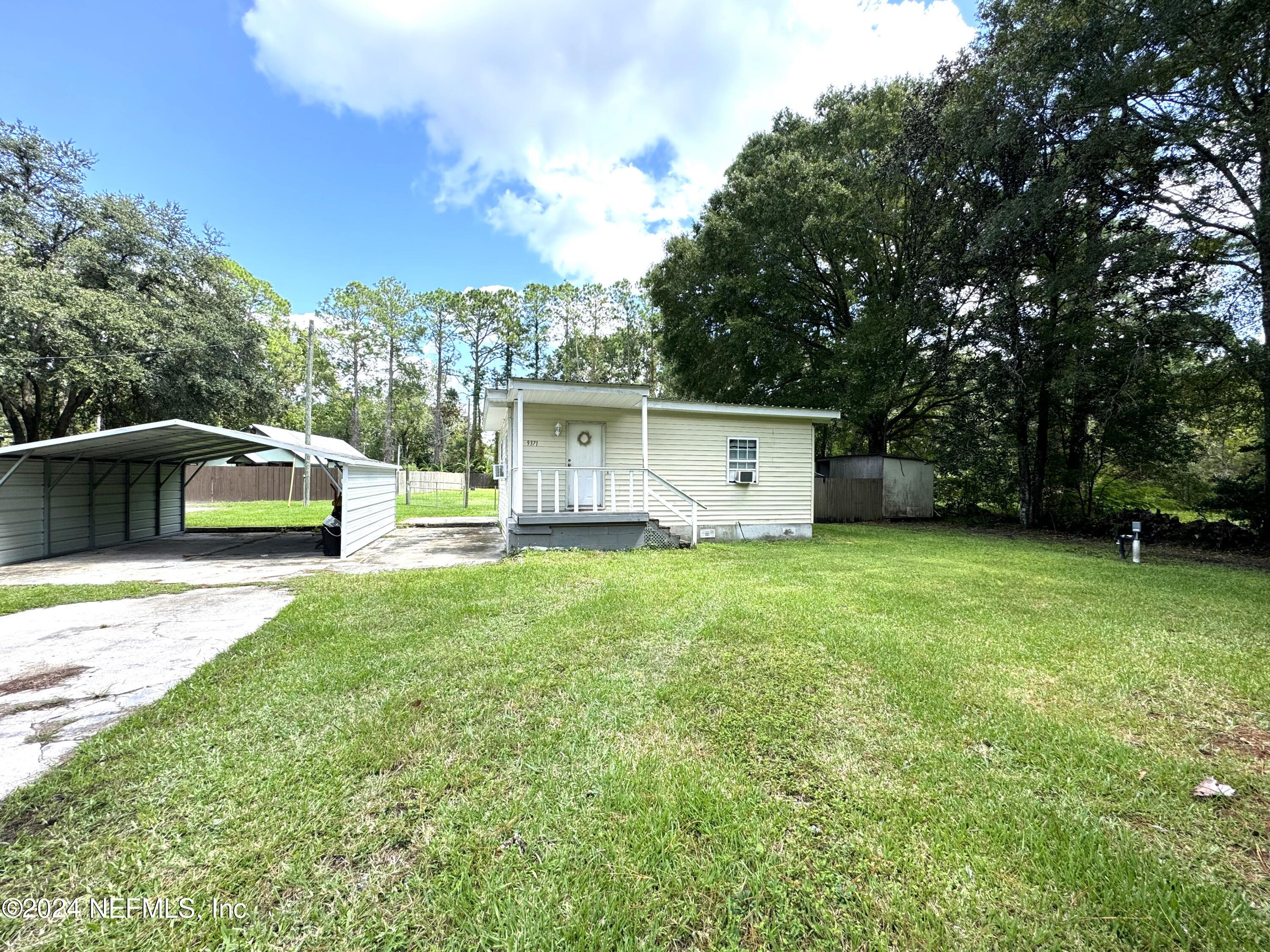 a front view of house with yard and trees