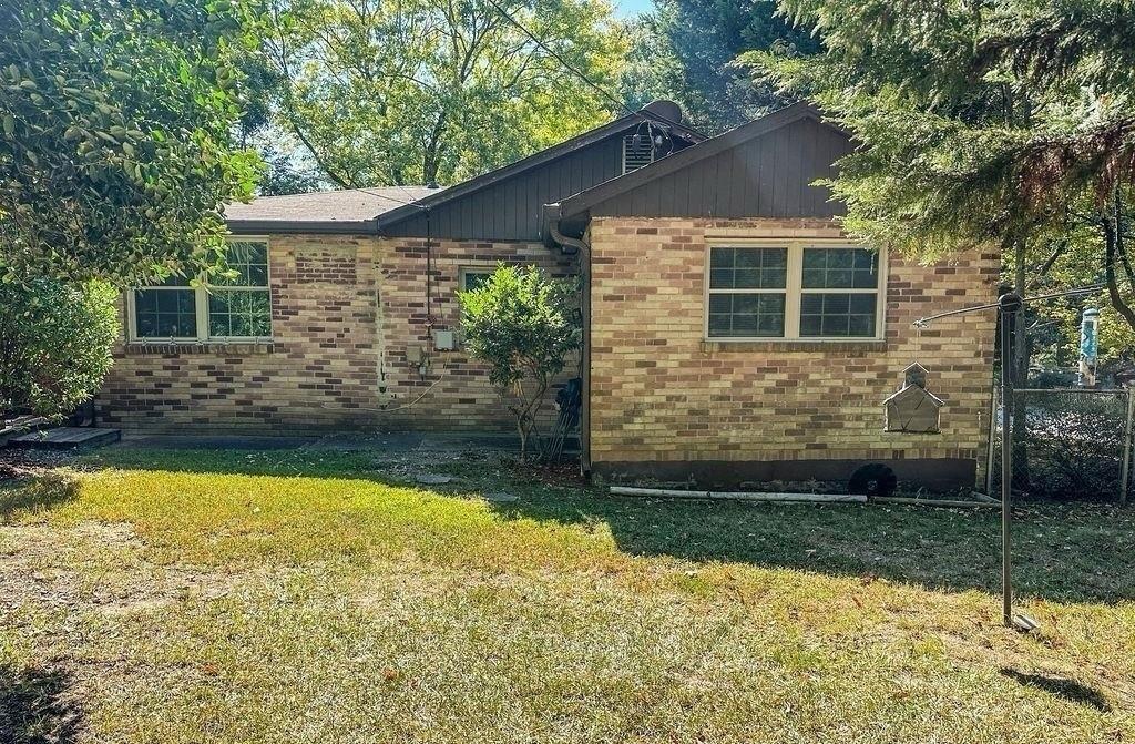 a view of house that has a large pool with a yard