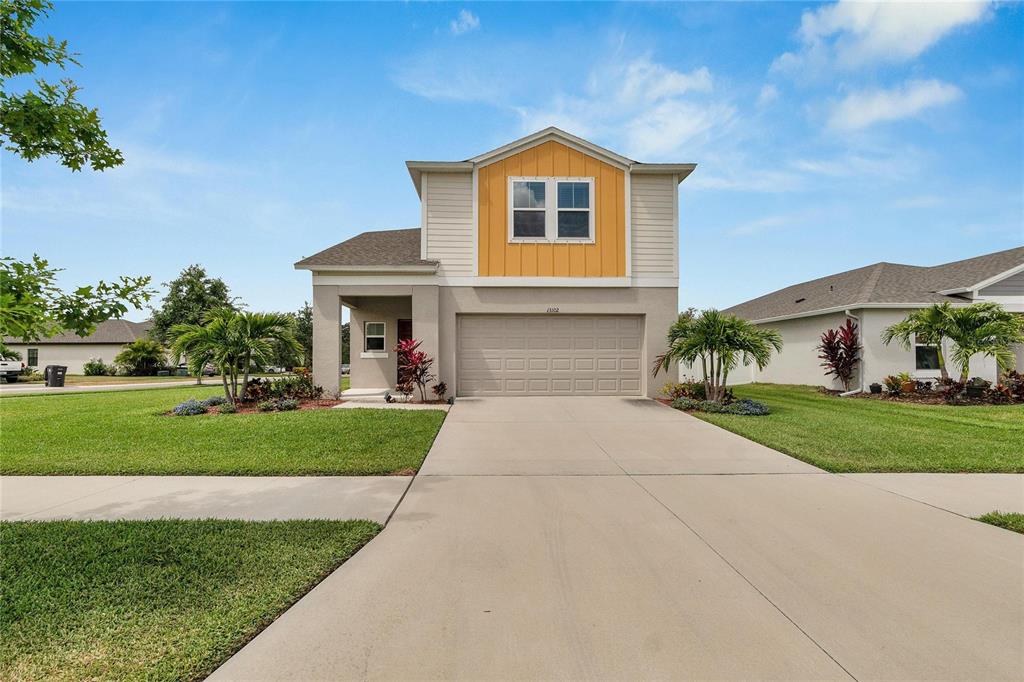 a front view of a house with a yard and garage