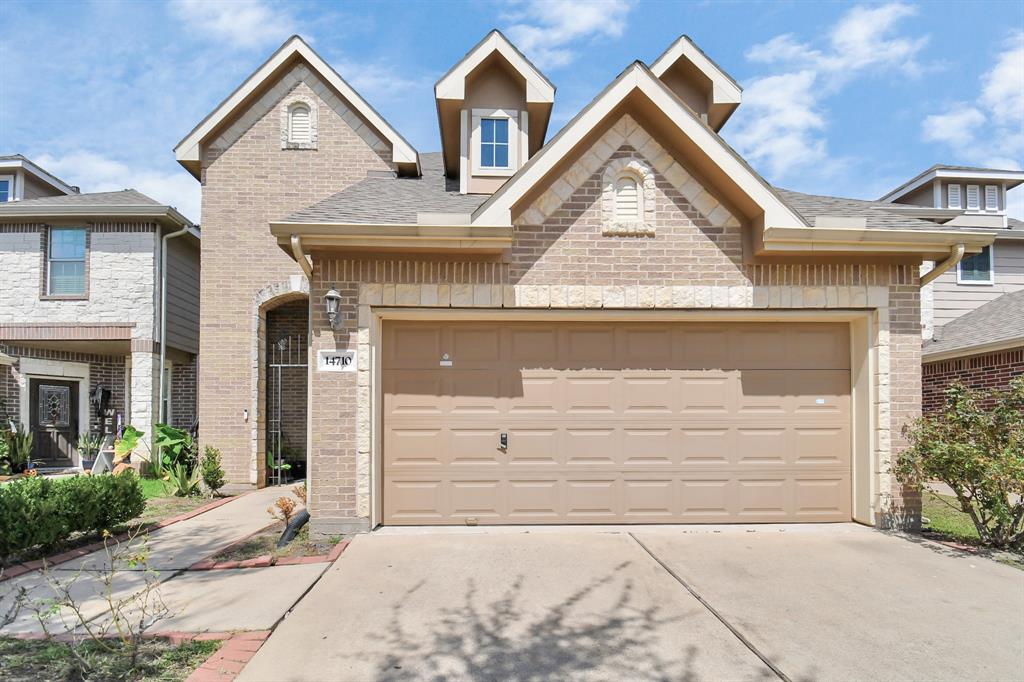 a front view of a house with garage