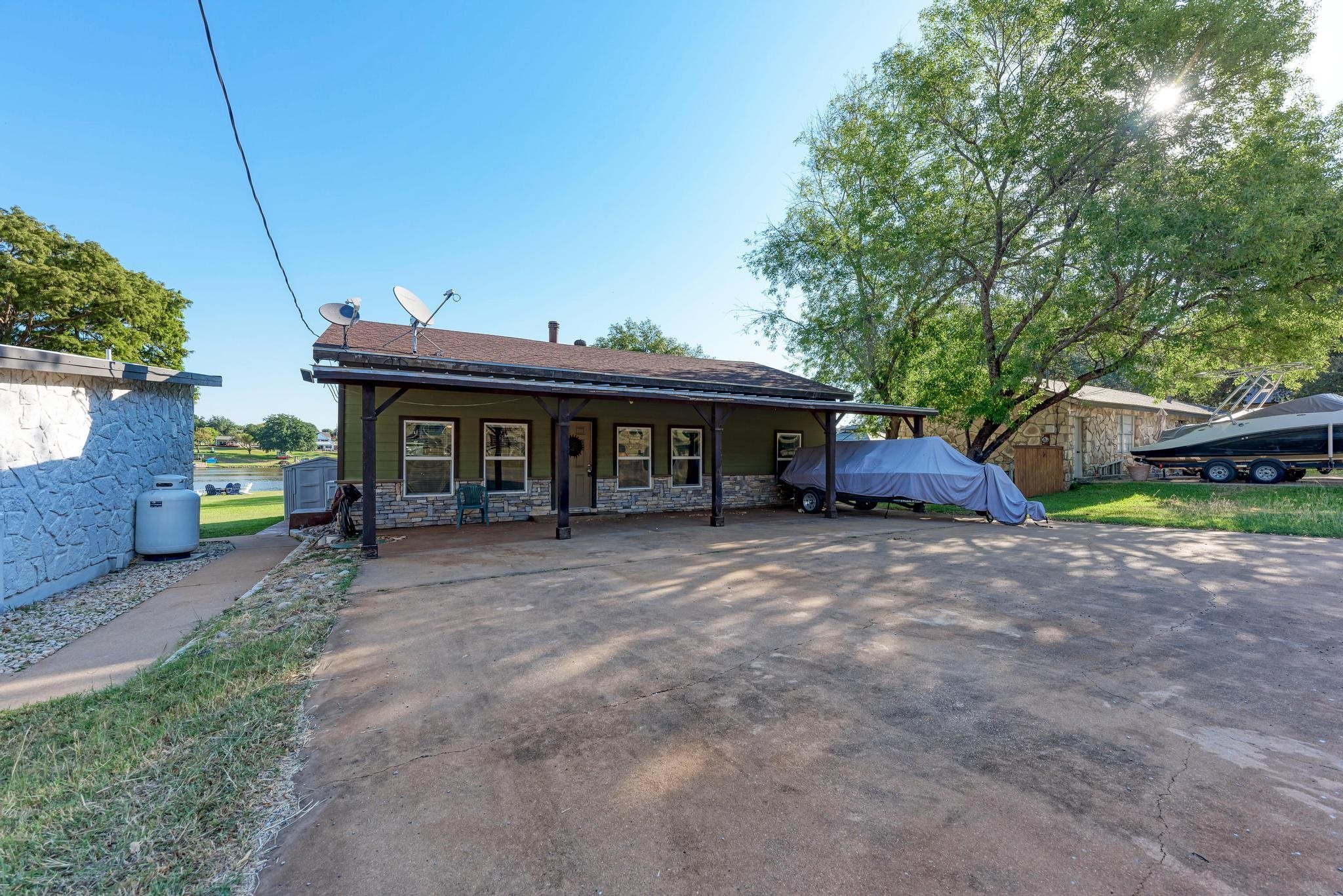 a view of a house with a yard and porch