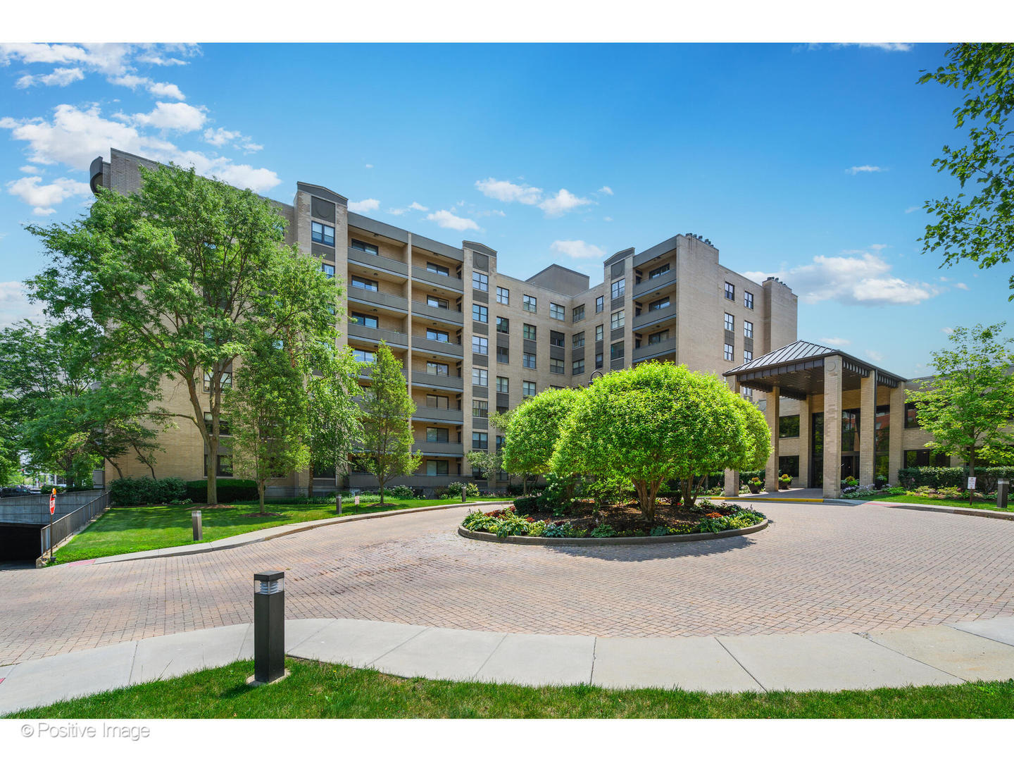 a front view of a residential apartment building with a yard