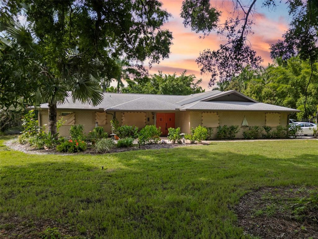 a front view of a house with garden