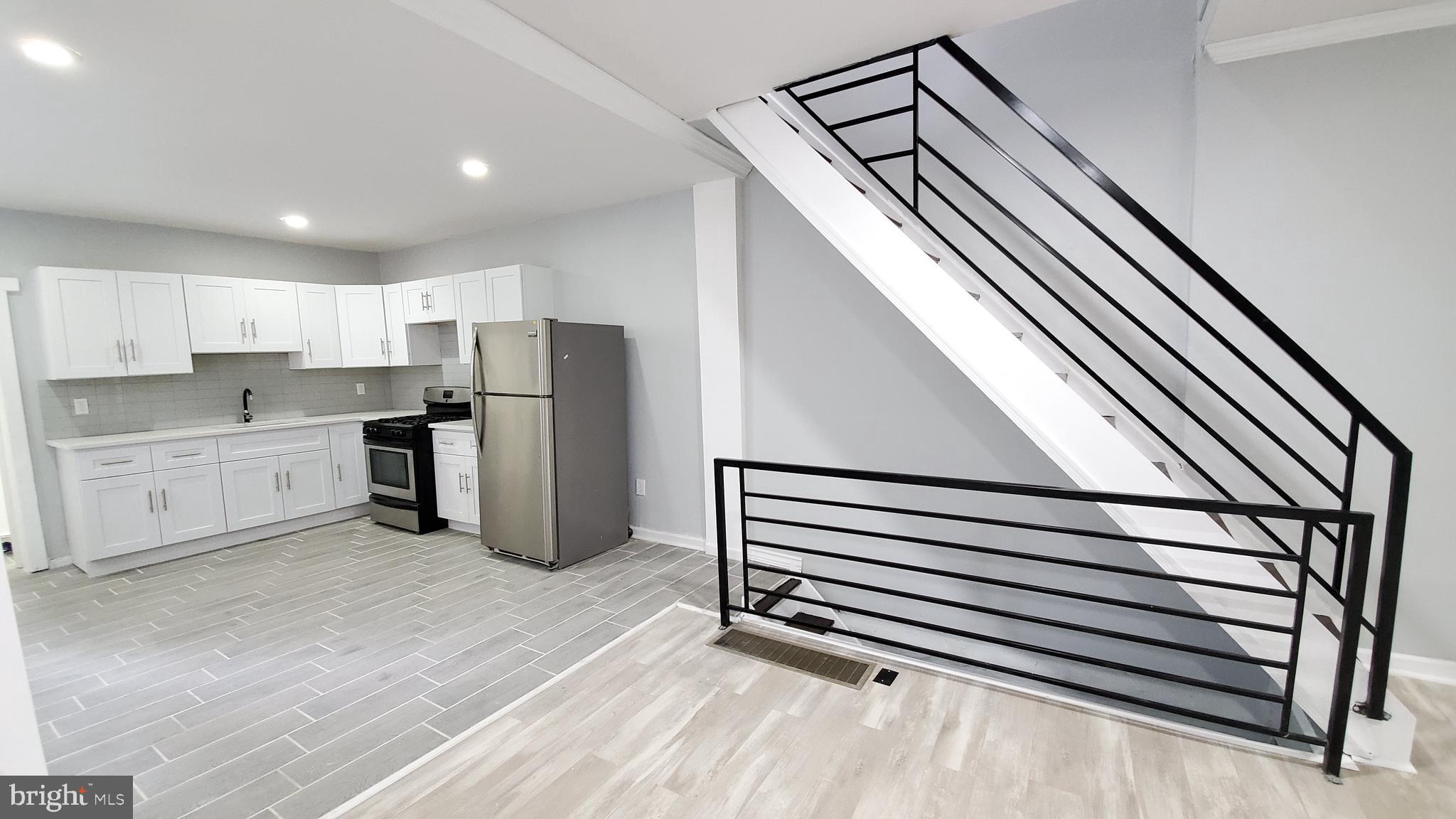 a kitchen with refrigerator and cabinets