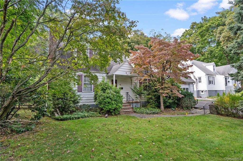 a view of backyard of house with green space