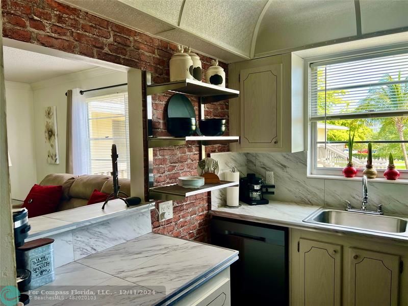 a kitchen with a sink cabinets and window