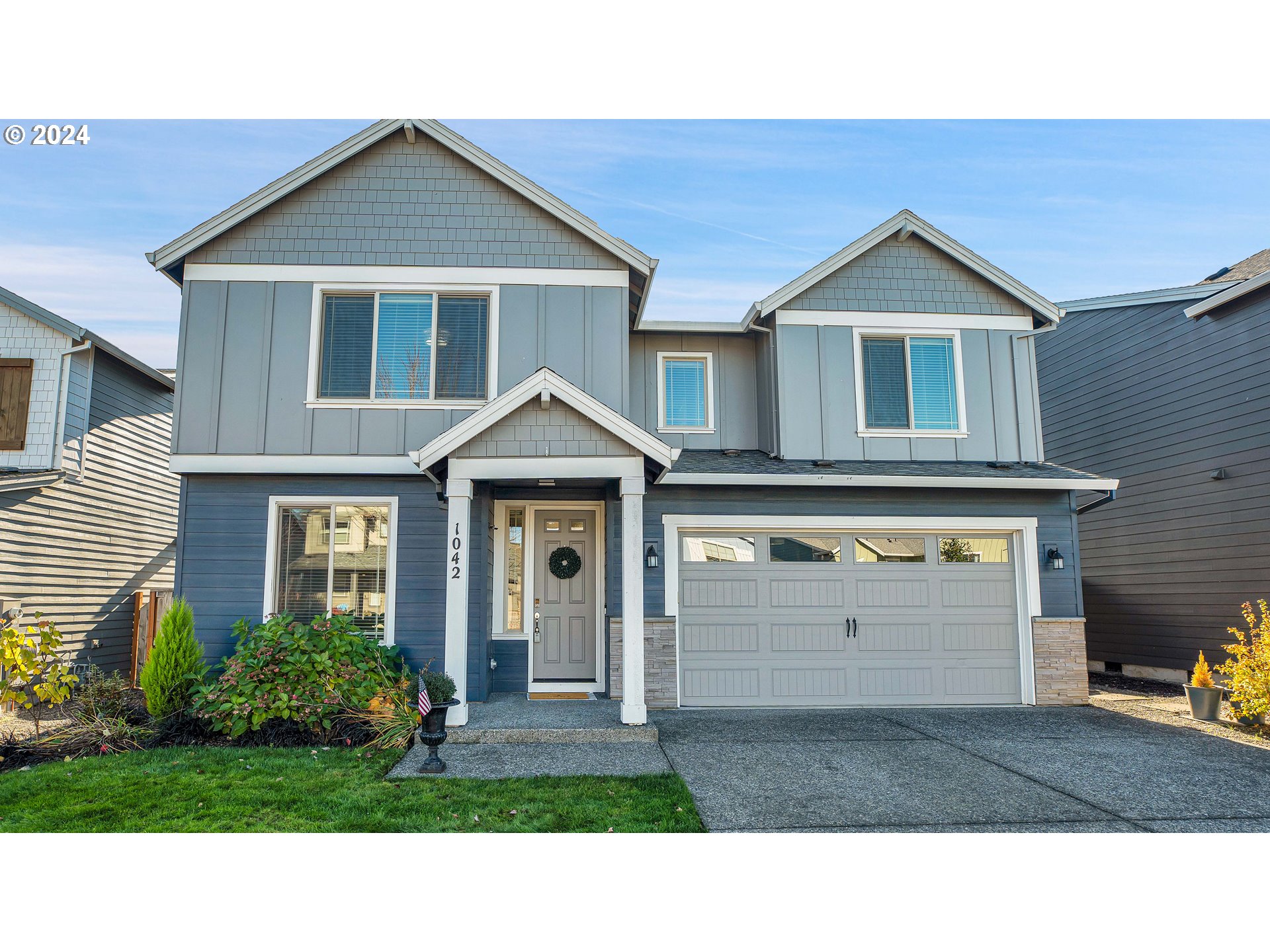 a front view of a house with a yard and garage