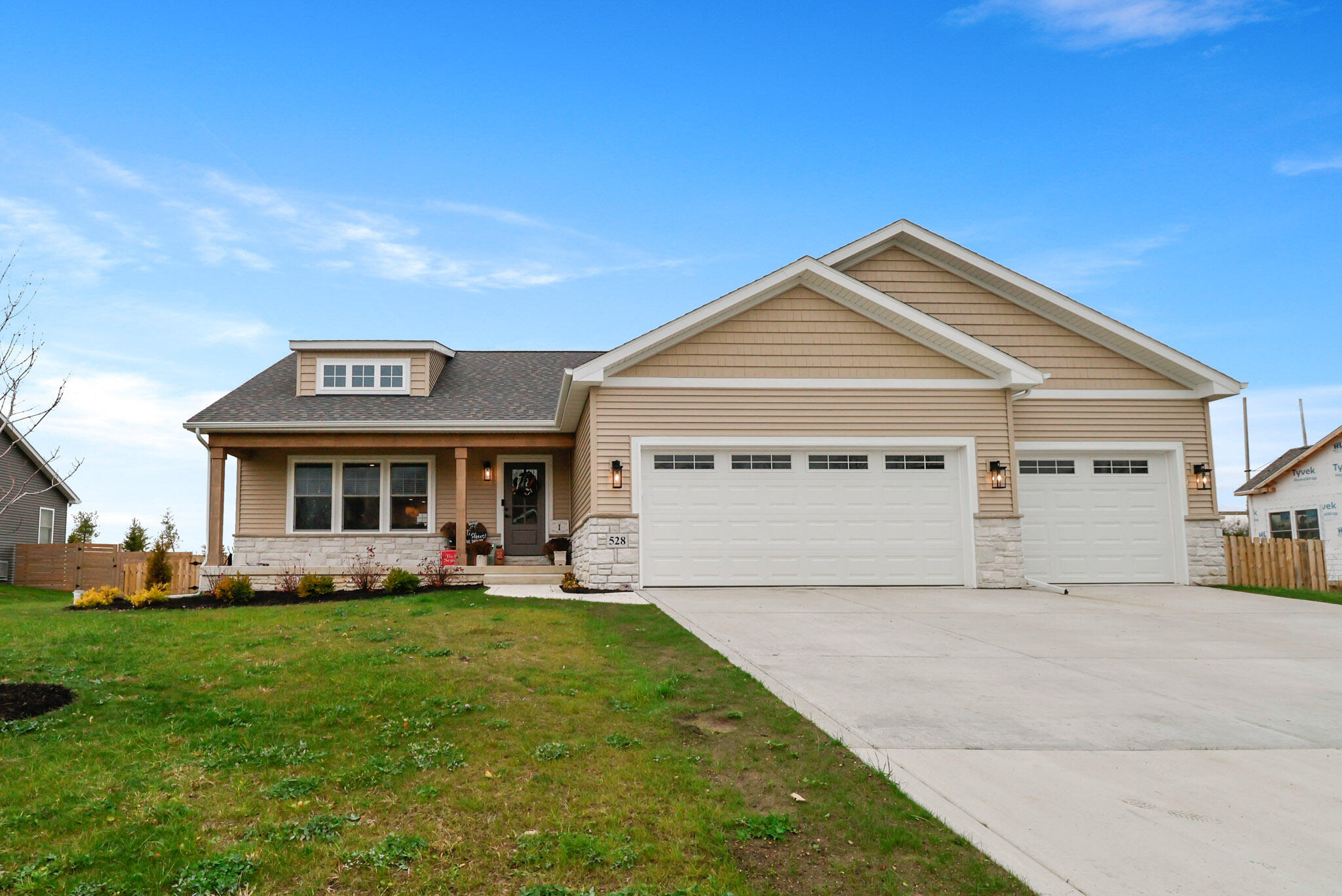 a front view of house with yard and green space