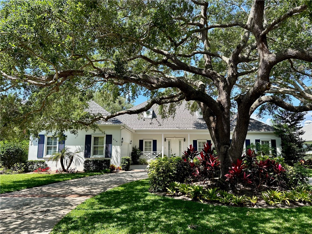 a view of a house with a tree