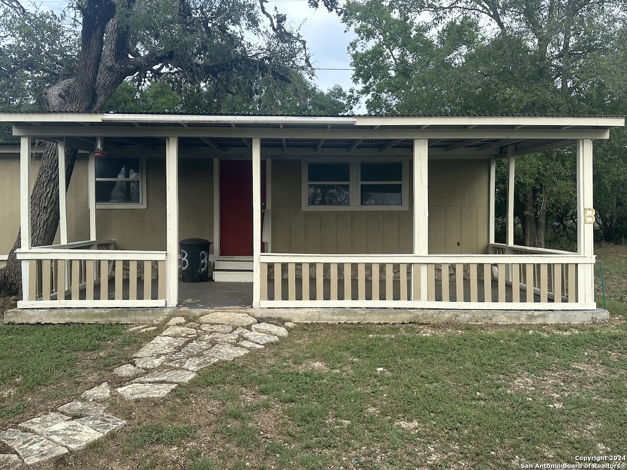 a view of a wooden deck and a yard