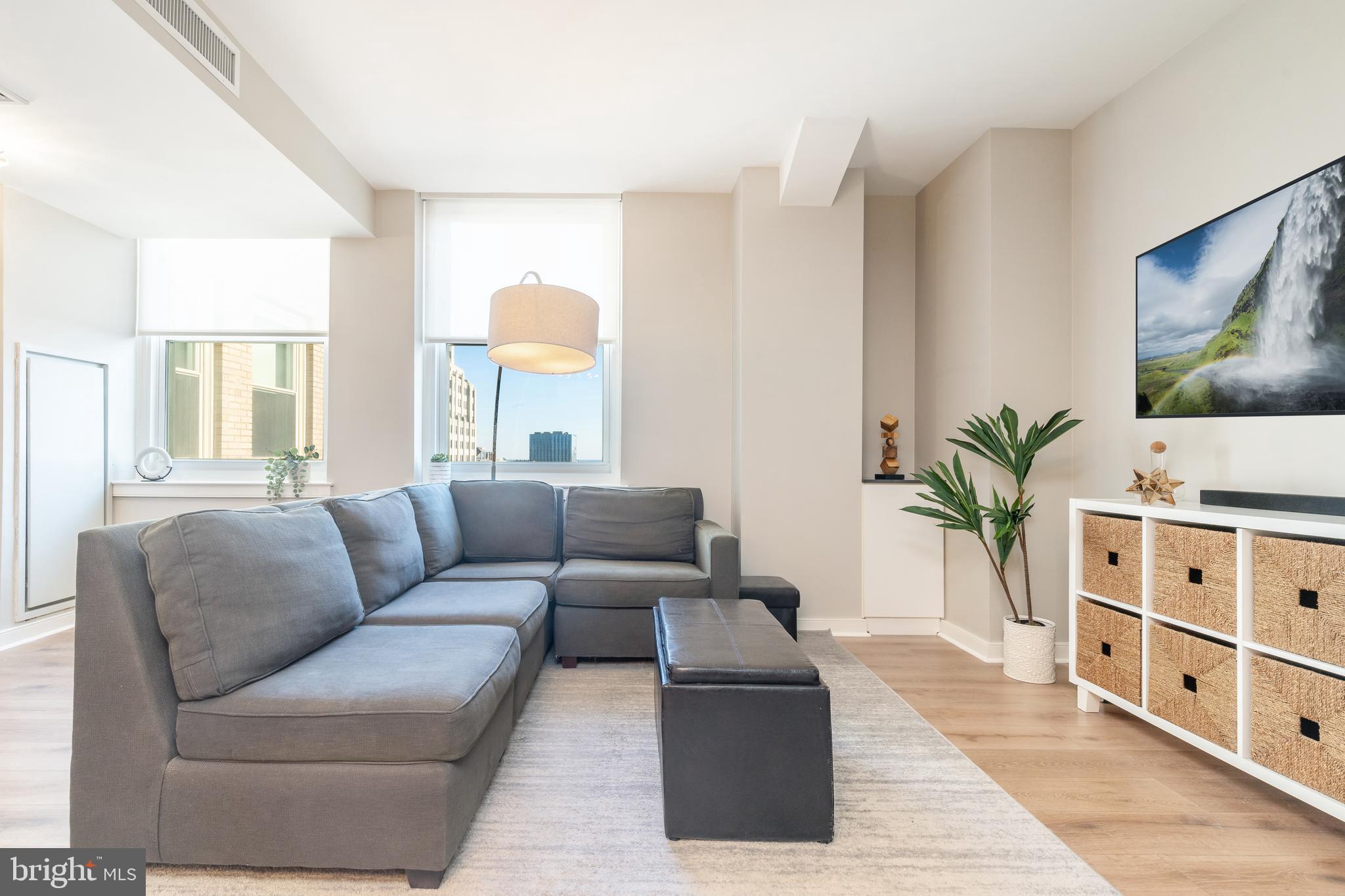 a living room with furniture and a flat screen tv