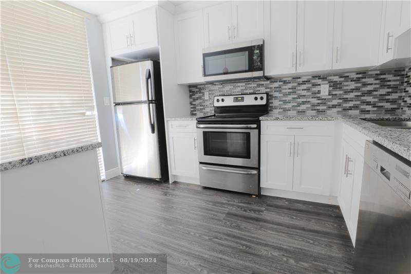 a kitchen with a stove and a refrigerator