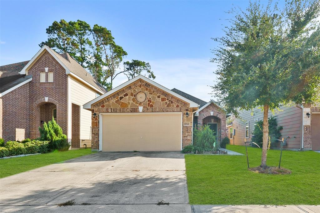 a front view of a house with a yard and garage