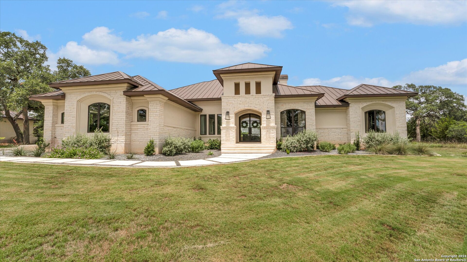 a front view of a house with a garden