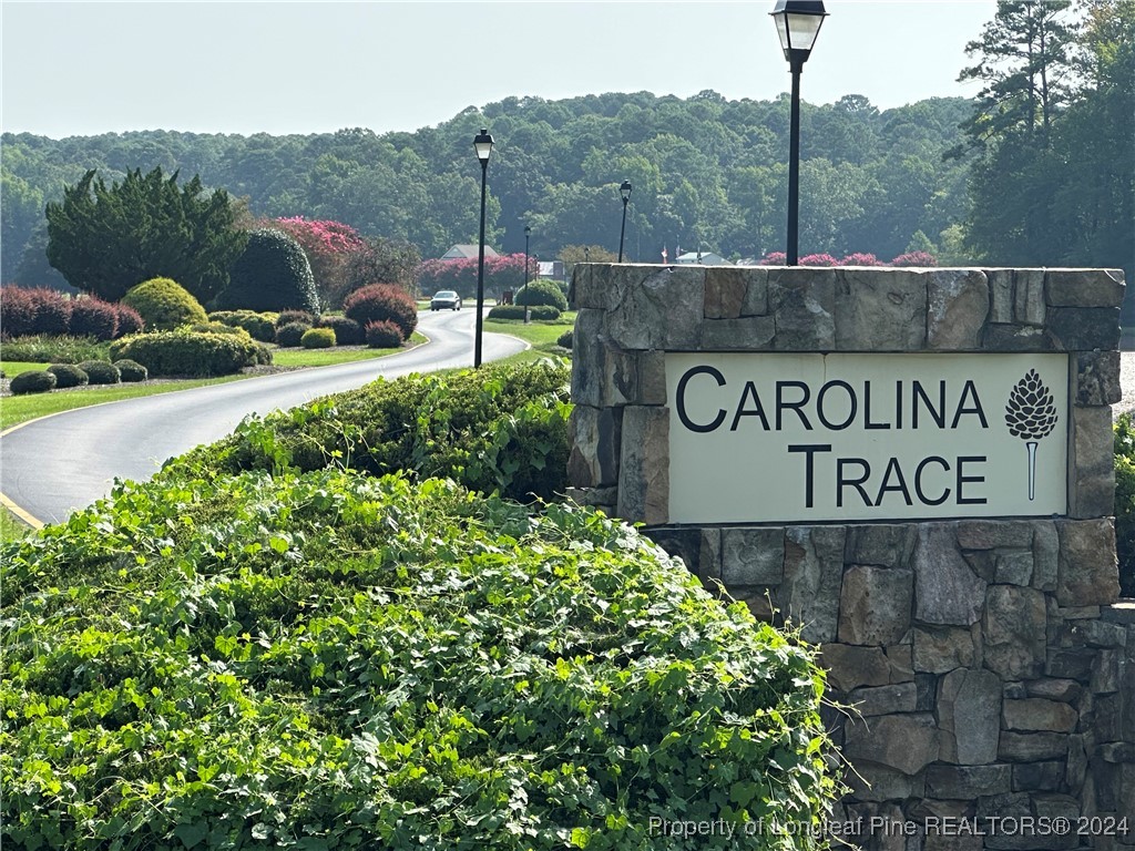 a view of sign board with buildings in the background