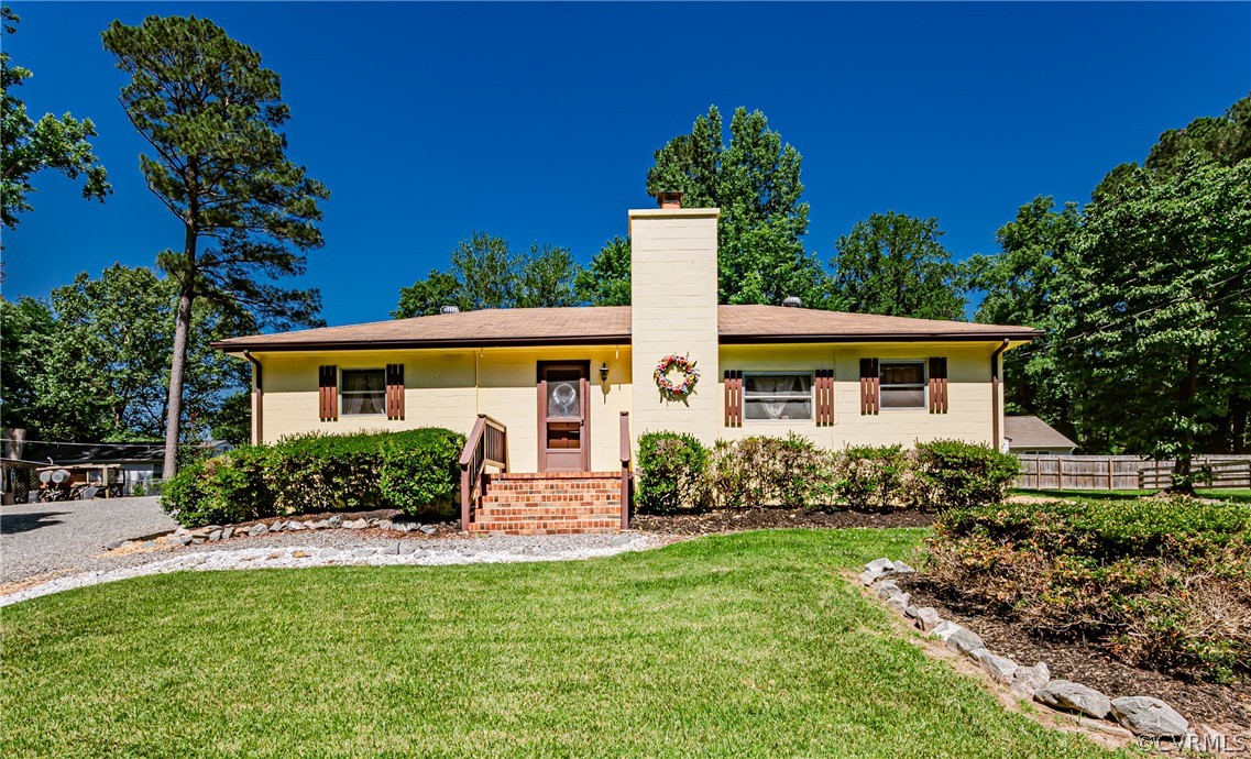 a front view of house with yard and green space