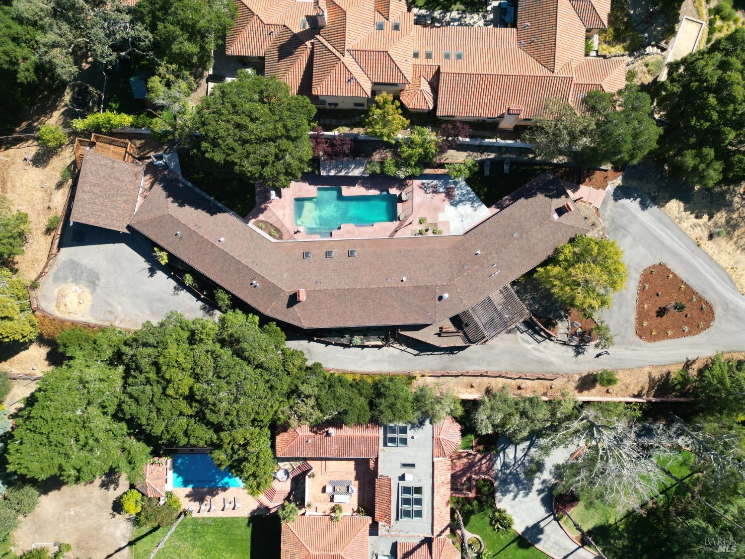 an aerial view of a house with a yard and garden