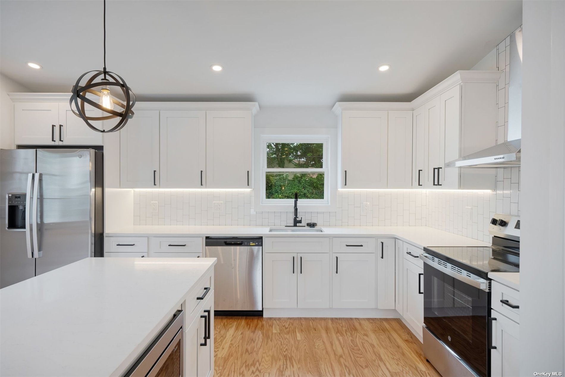 a kitchen with a sink a stove and cabinets