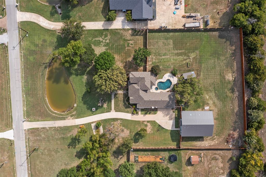 an aerial view of a house with swimming pool outdoor seating and yard