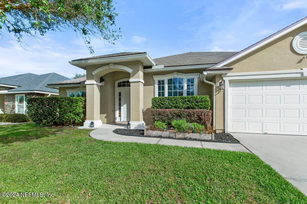 a front view of a house with a yard