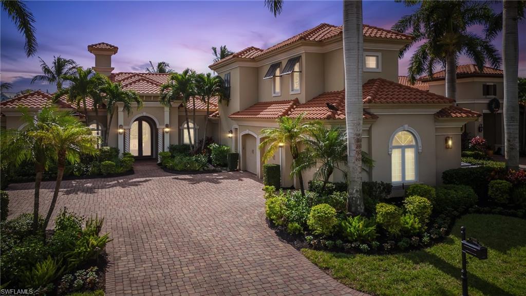 Mediterranean / spanish house with a lawn and french doors