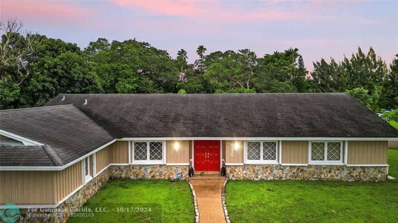 a aerial view of house with yard and outdoor seating