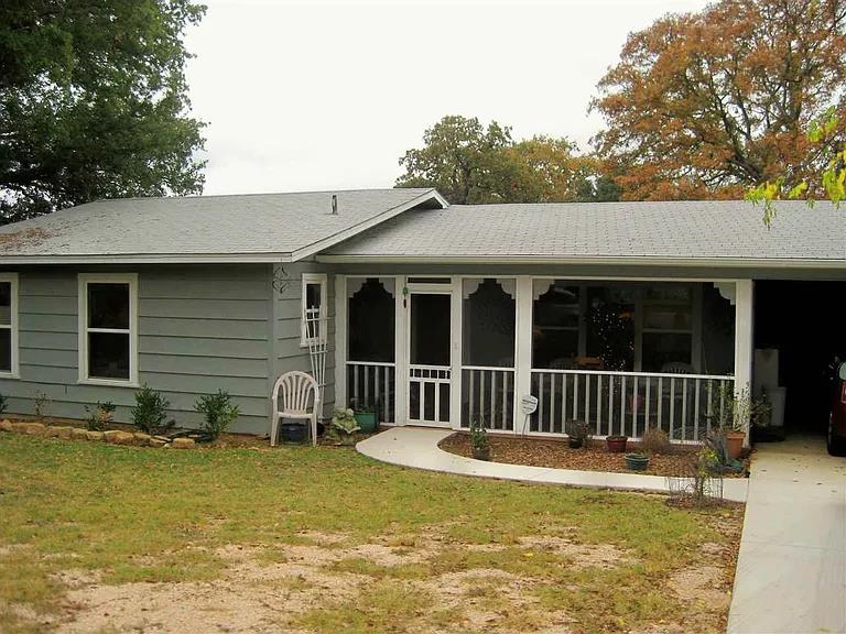 a view of a house with a swimming pool and a yard