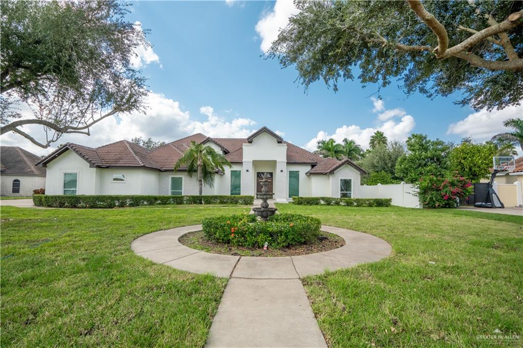 a front view of house with yard and green space