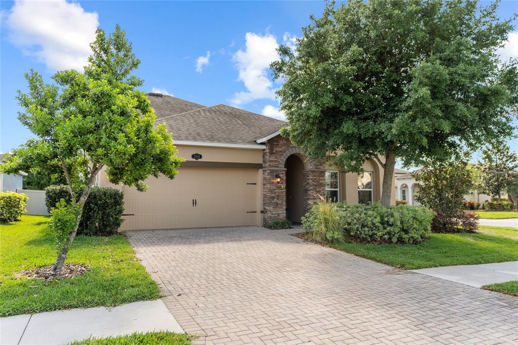 a front view of a house with a yard and garage