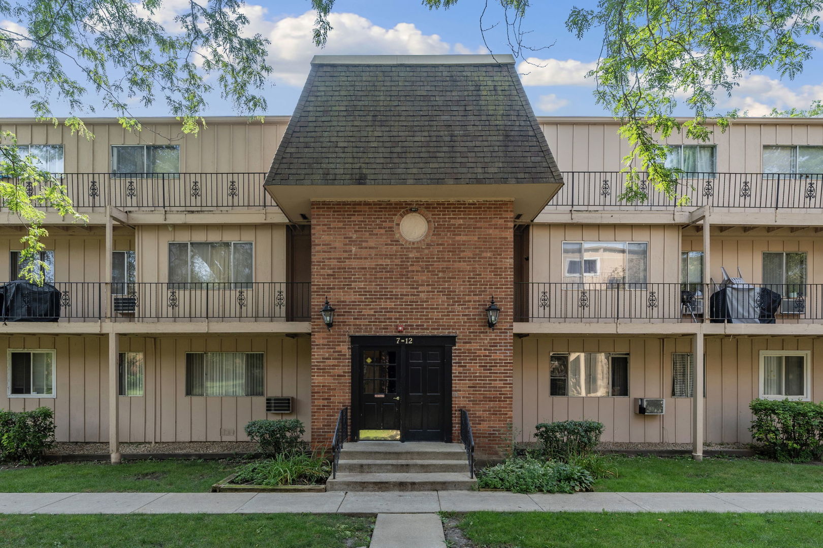 a front view of a house with a garden