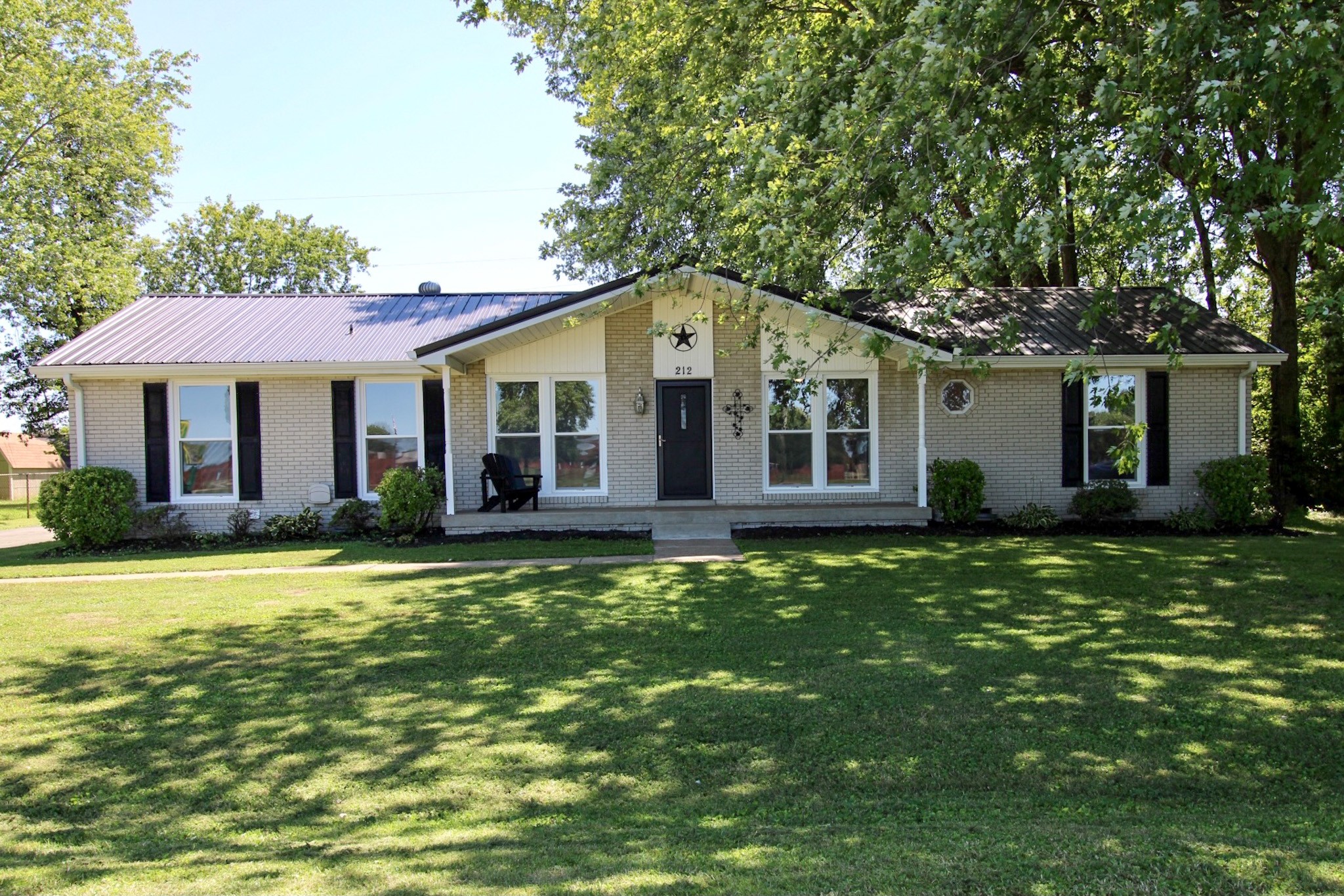 a front view of a house with a garden