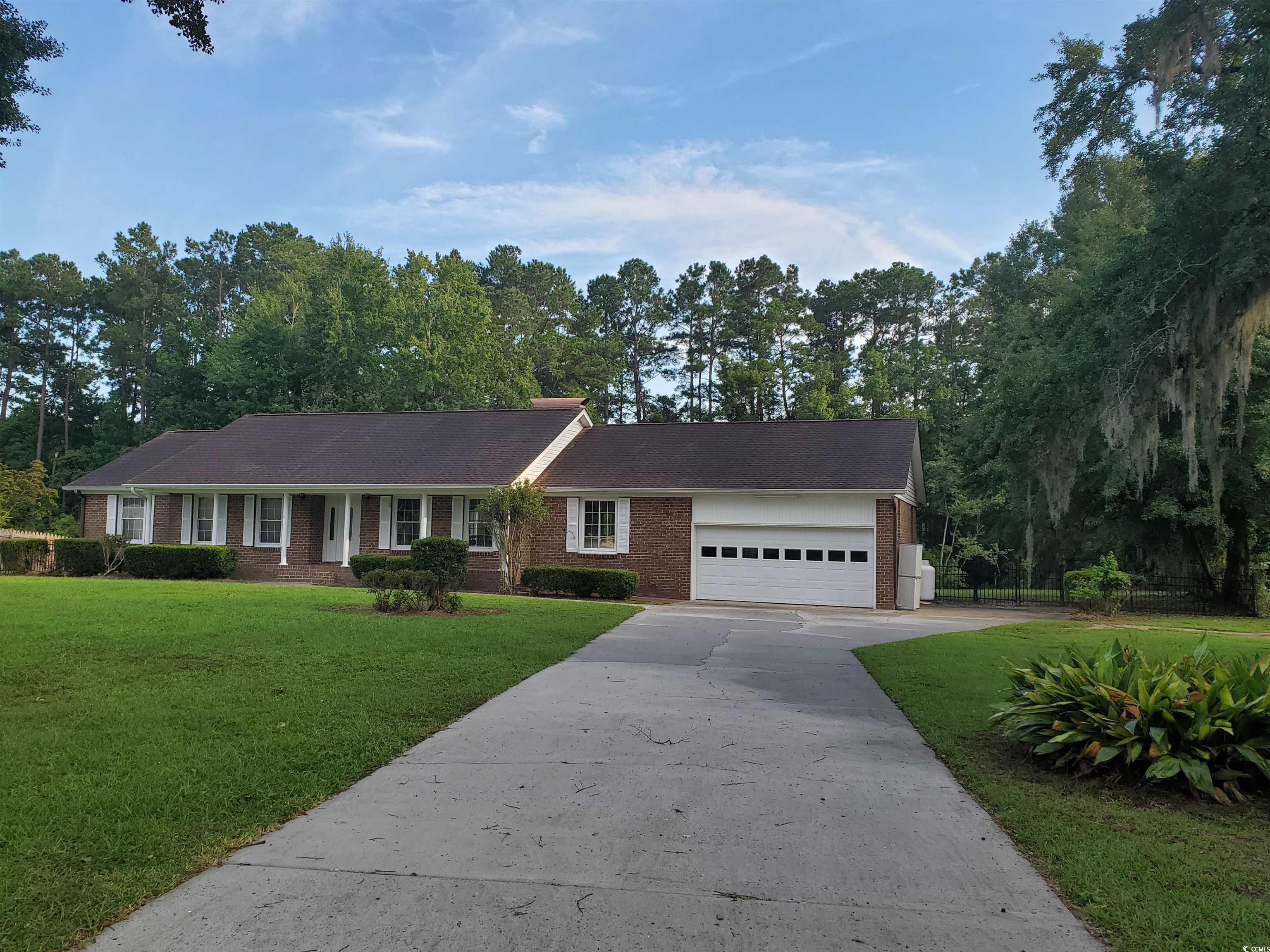 Single story home with a front yard and a garage