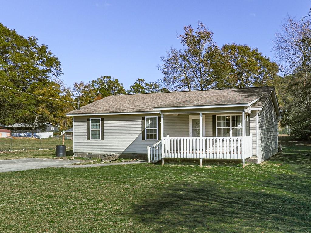 a front view of a house with a garden