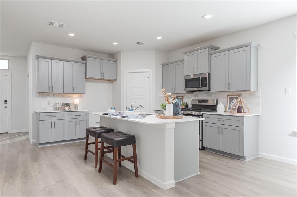 a kitchen with cabinets a sink and white appliances