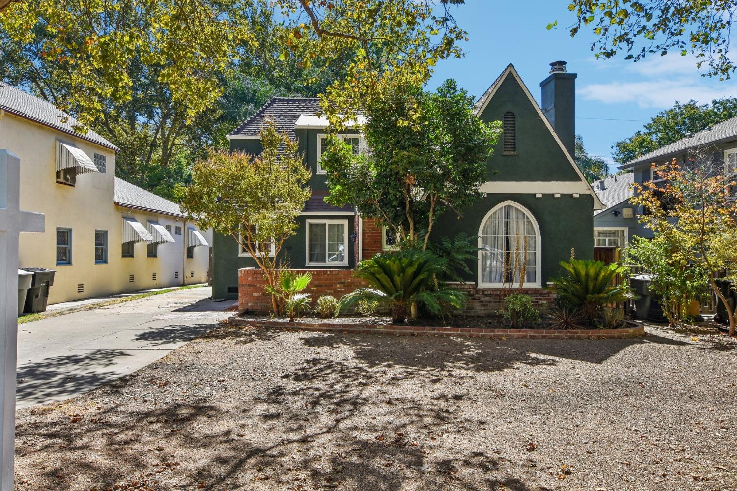 a view of a house with backyard and sitting area