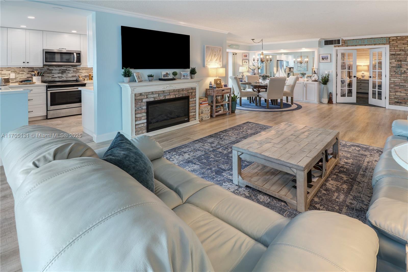 a living room with furniture fireplace and flat screen tv